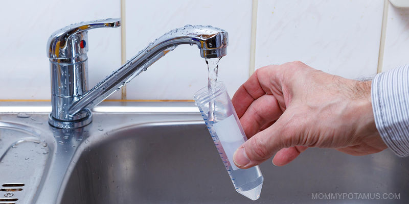 Pouring water from faucet into test tube