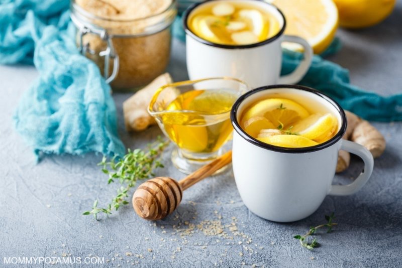 cup of peppermint tea on a table with honey