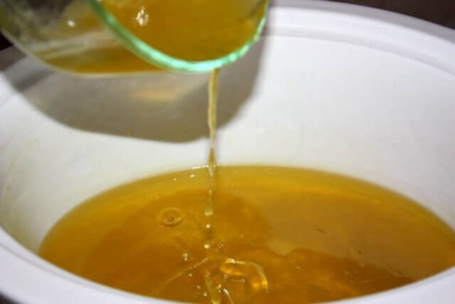 Step 2: Place melted oils and liquid oils (olive, castor, jojoba) in a crockpot and set to low