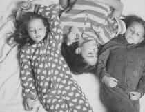 kids in pajamas lying on the floor