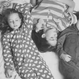 kids in pajamas lying on the floor