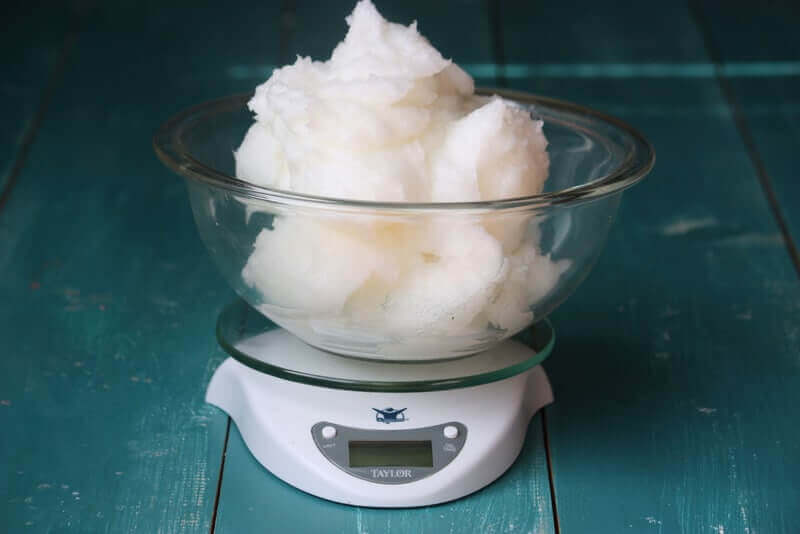 weighing coconut oil for soap