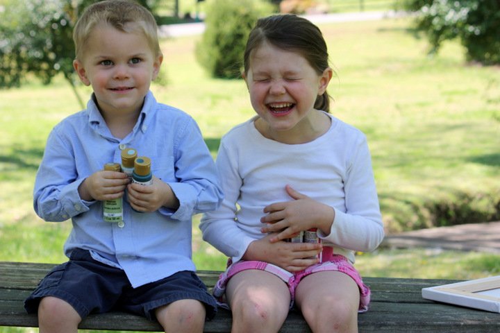 girl and boy laughing while making a DIY project