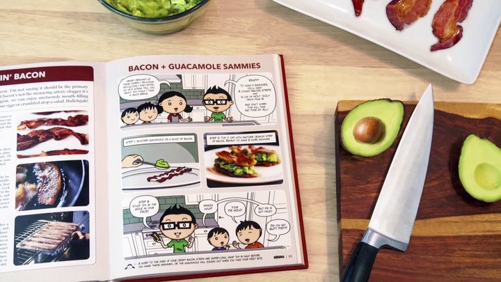 open cookbook beside a knife and a sliced avocado