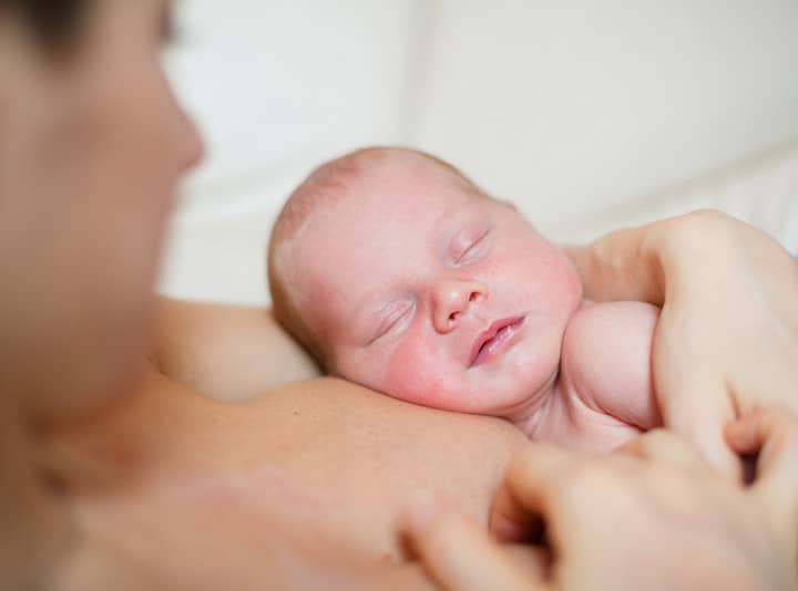 Mom holding baby skin to skin