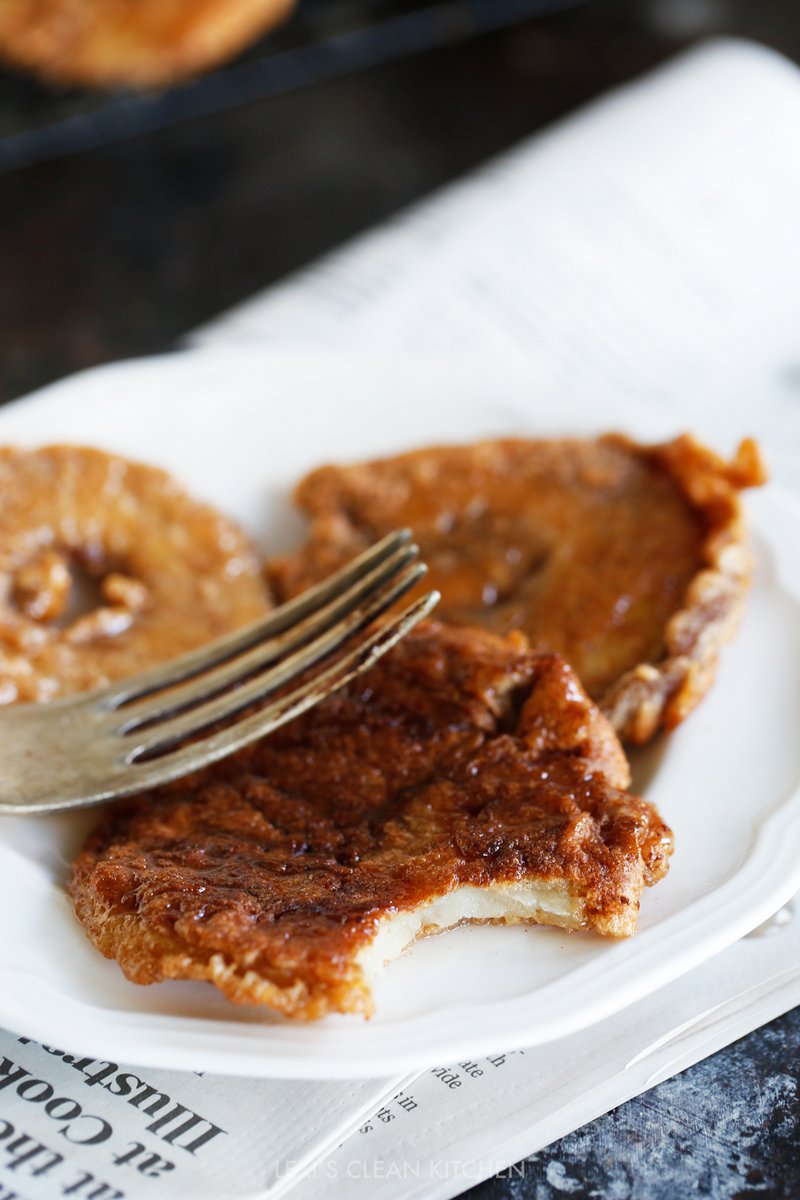 apple fritters on a plate with a fork