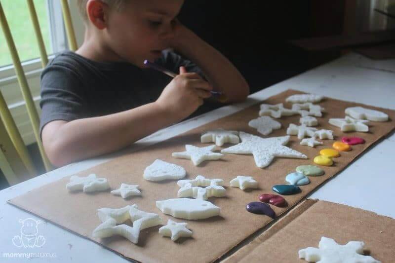 boy deciding which colors to paint the ornaments