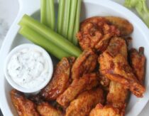 Baked buffalo wings on table