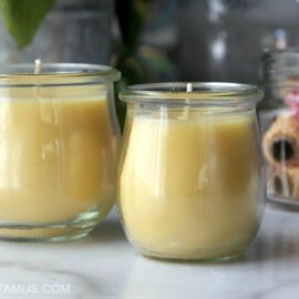 two homemade beeswax candles on a counter