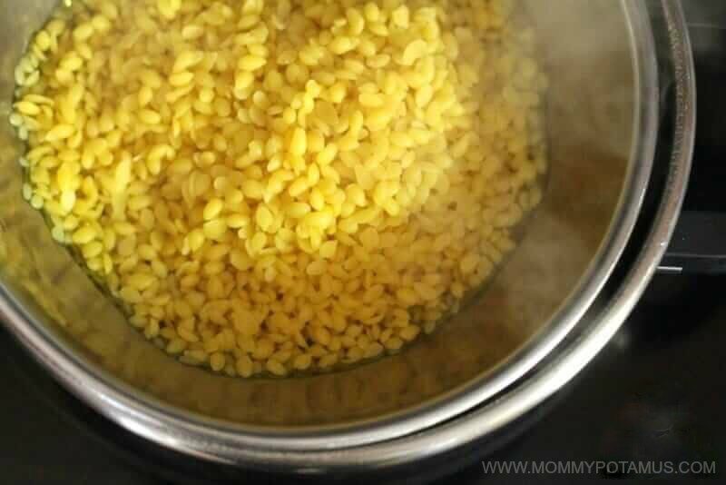 Yellow beeswax pellets in a bowl