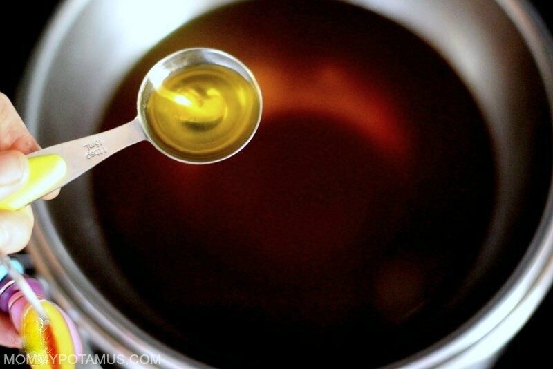 Melted beeswax in a metal bowl