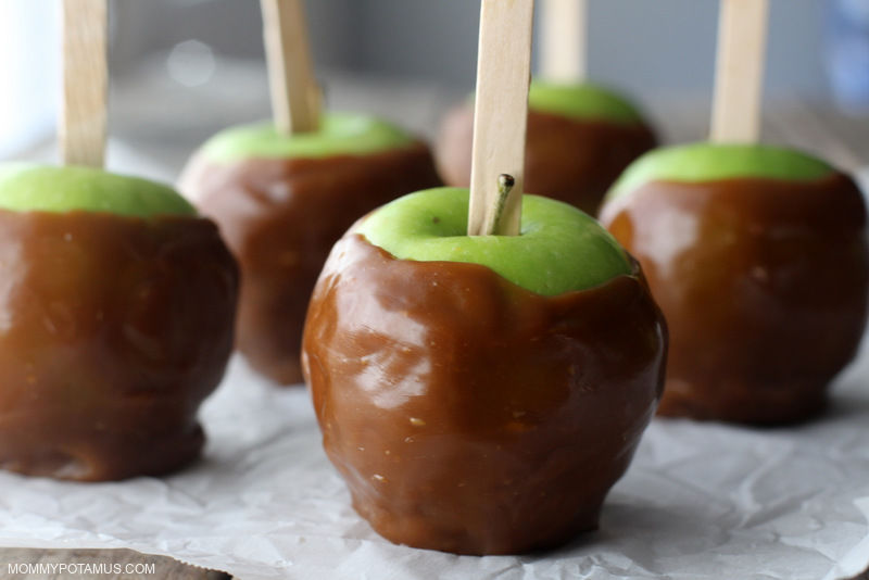 Plain caramel apples on parchment paper