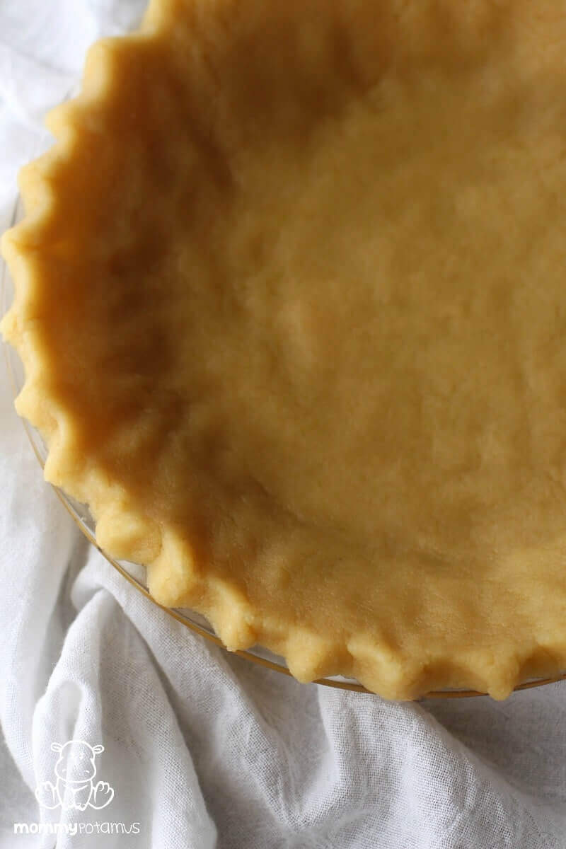 Overhead view of unbaked almond flour pie crust in pan