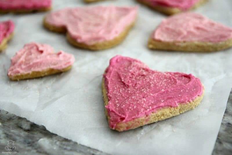 Gluten-free sugar cookies on parchment paper and baking sheet
