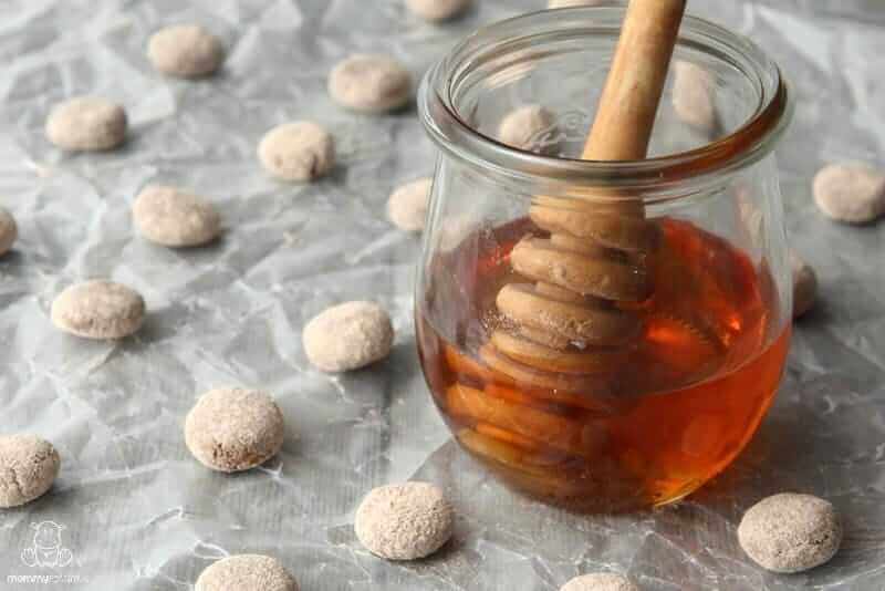 Homemade cough drops next to jar of honey