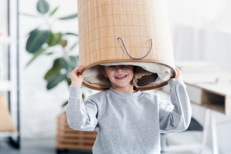 Child holding laundry basket