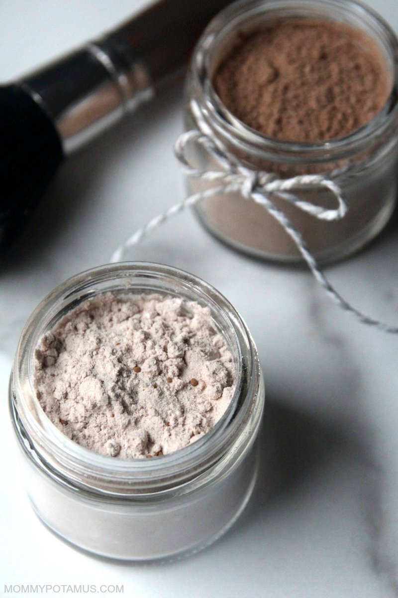 Jars of DIY dry shampoo and makeup brush for applying