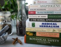 Stack of herbal books on table