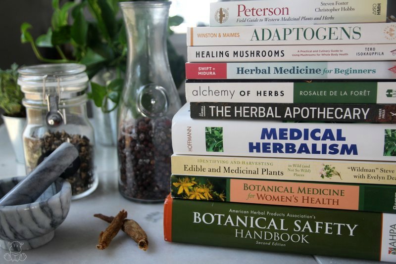 Stack of herbal books on table