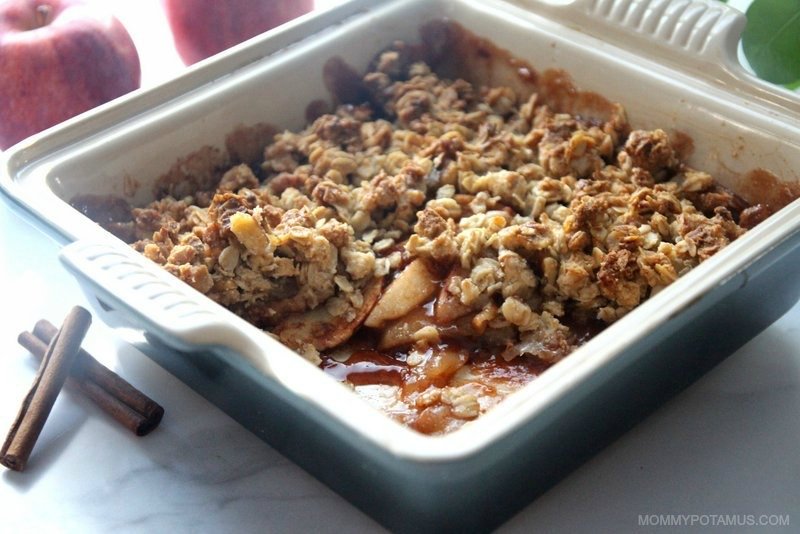 Freshly baked apple crisp in a square, white Le Creuset dish