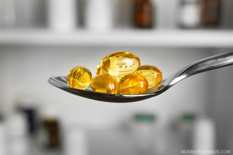 Vitamin E capsules on a spoon