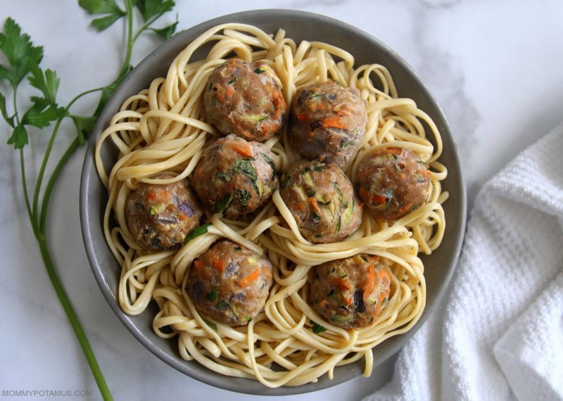 Ovenb-baked turkey meatballs over a bowl of pasta