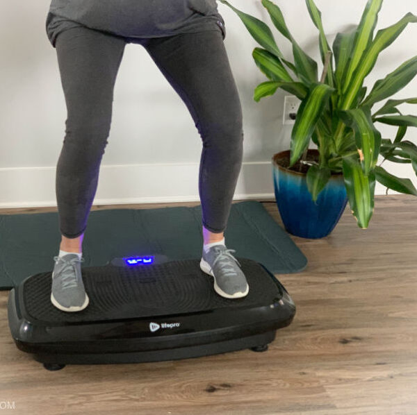 woman standing on top of vibration plate