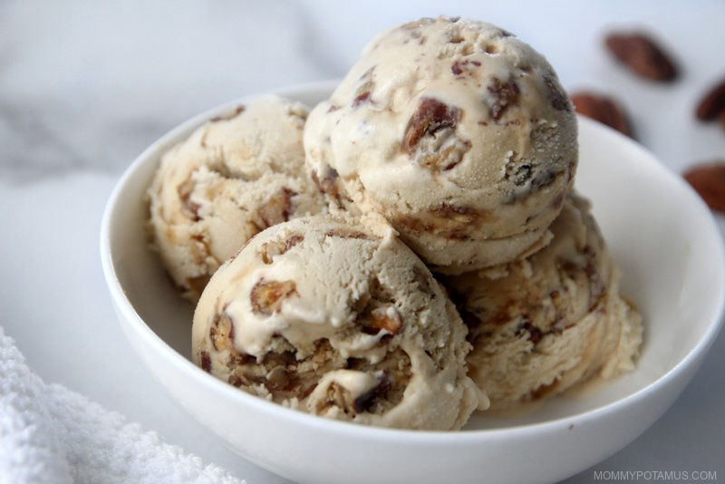 Four scoops of homemade dairy-free butter pecan ice cream in white bowl. 
