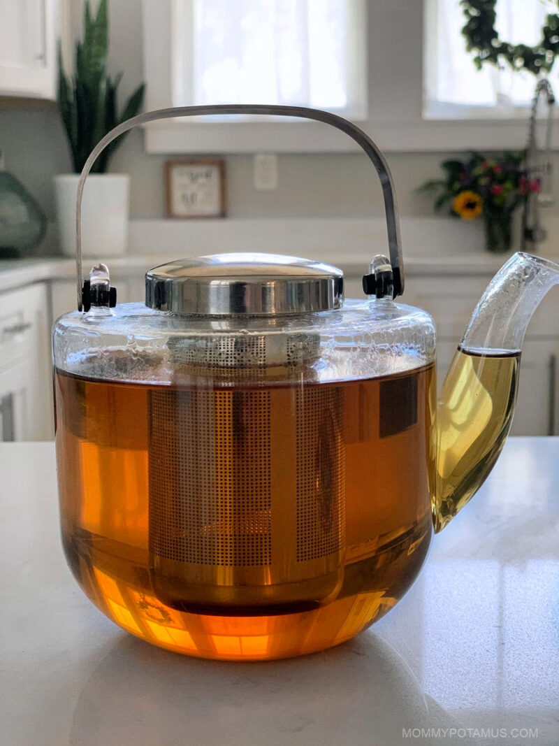 Lemon balm tea in glass teapot