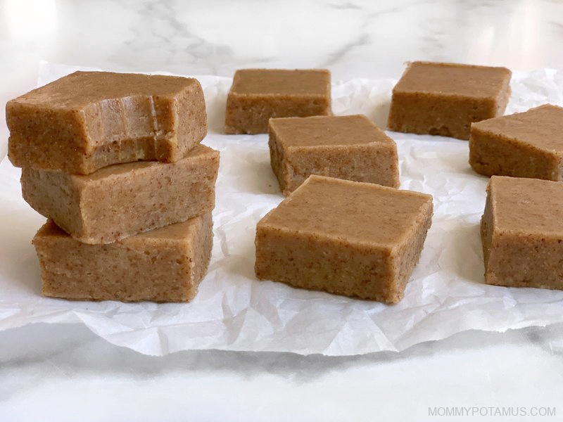 Almond butter fudge stacked on kitchen counter