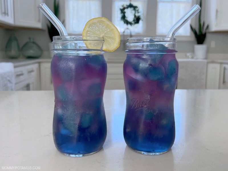 Butterfly pea flower lemonade in the process of changing color from blue to purple