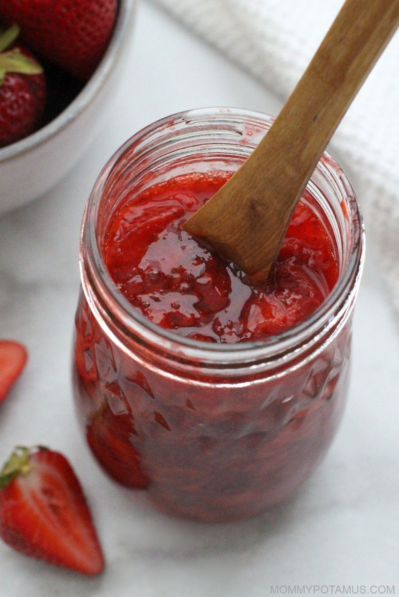 Overhead view of strawberry sauce in jar. 