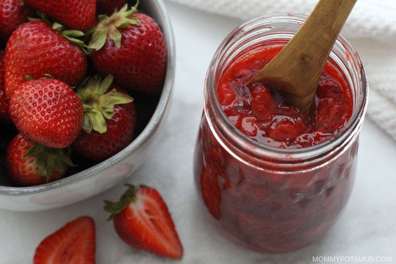 Strawberry sauce in jar on kitchen counter