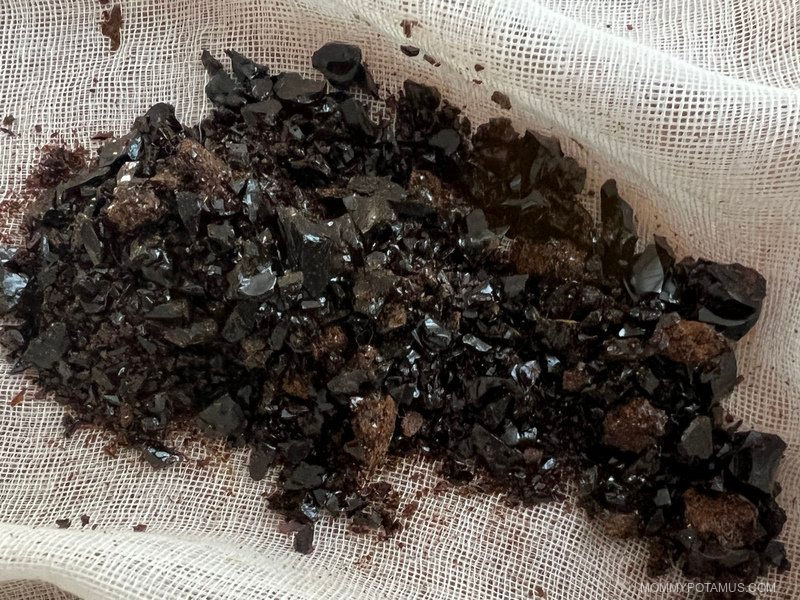 Up close image of dark brown propolis chunks