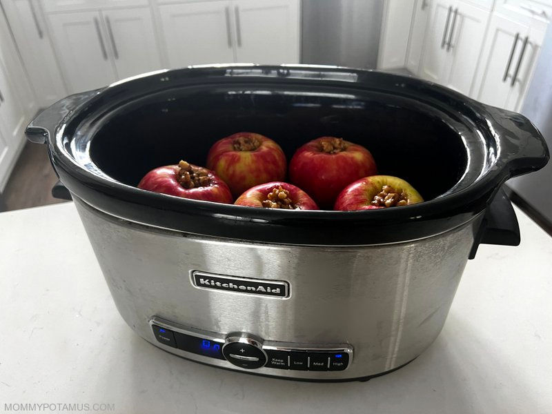 Stuffed pples nestled inside slow cooker