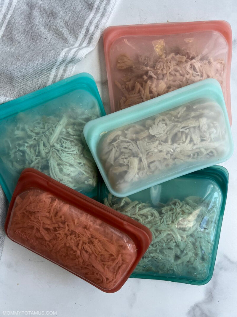 Overhead view of shredded chicken in silicone storage bags