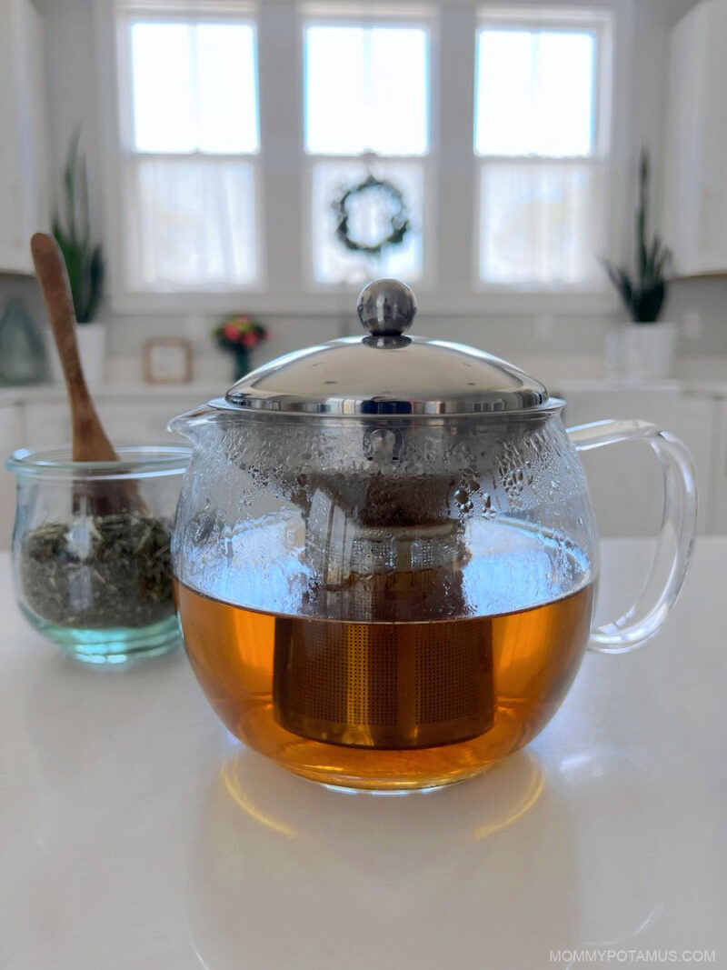 Up close view of glass kettle filled with blue vervain tea. 