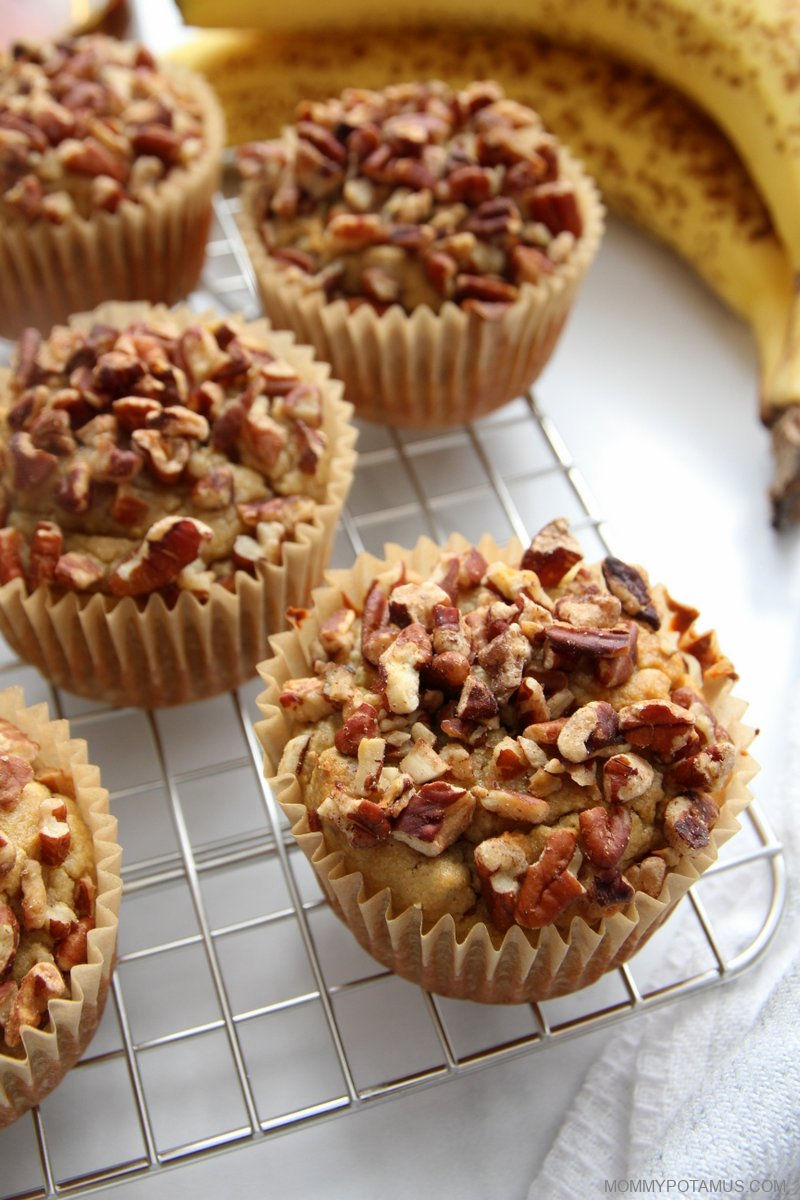 Second view of gluten-free banana nut muffins on cooling rack next to fresh bananas