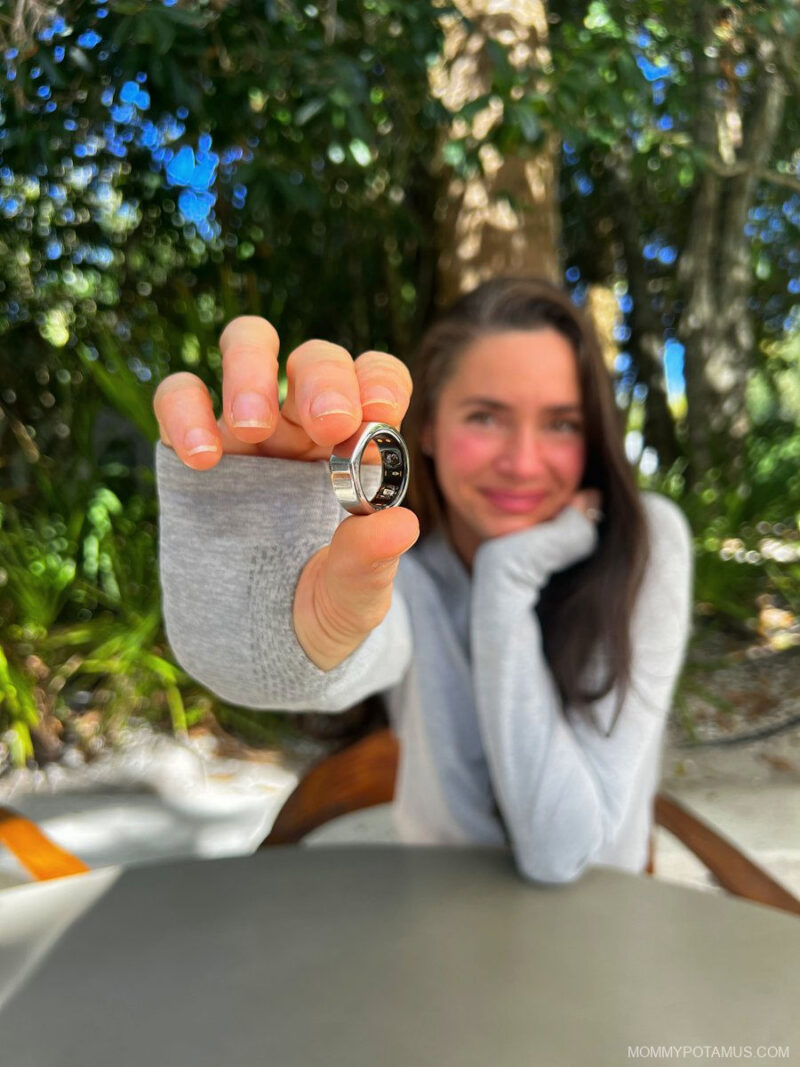 Heather holding Oura ring close to camera so that the internal sensors are visible.