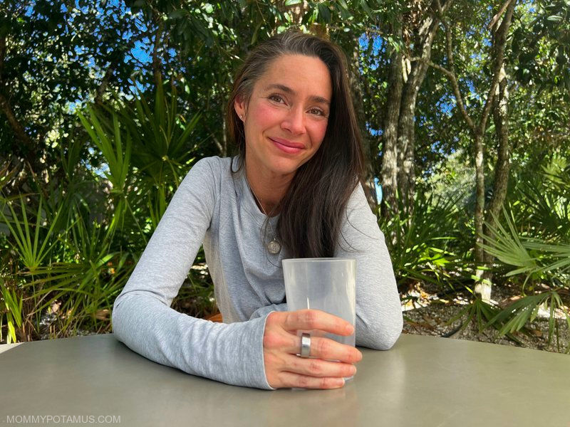 Heather holding water glass with Oura ring on hand