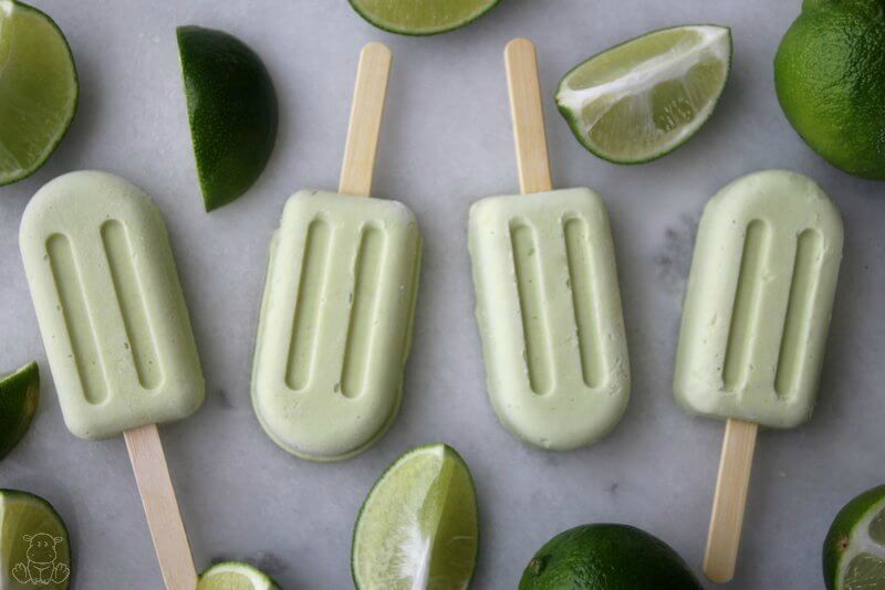 Key lime pie popsicles on marble countertop