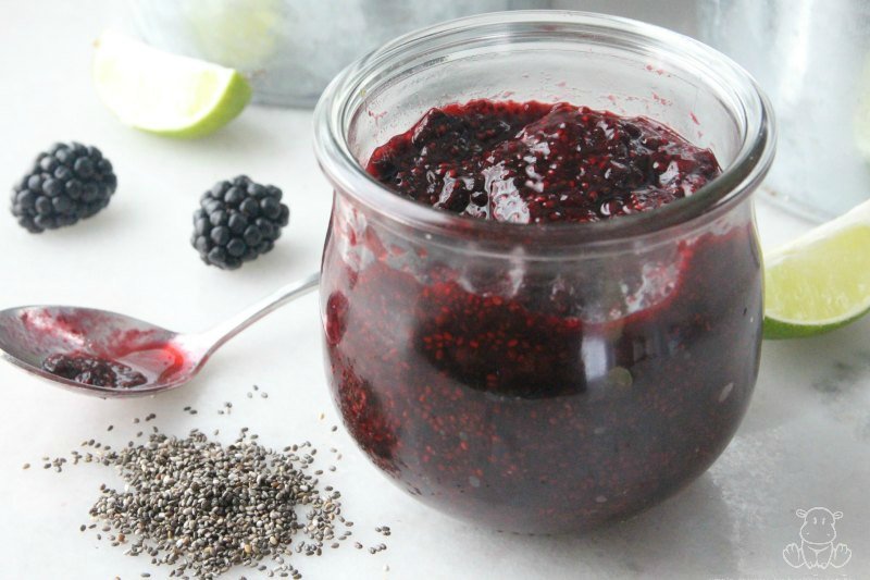 Jar of homemade blackberry jam with chia seeds in forefront
