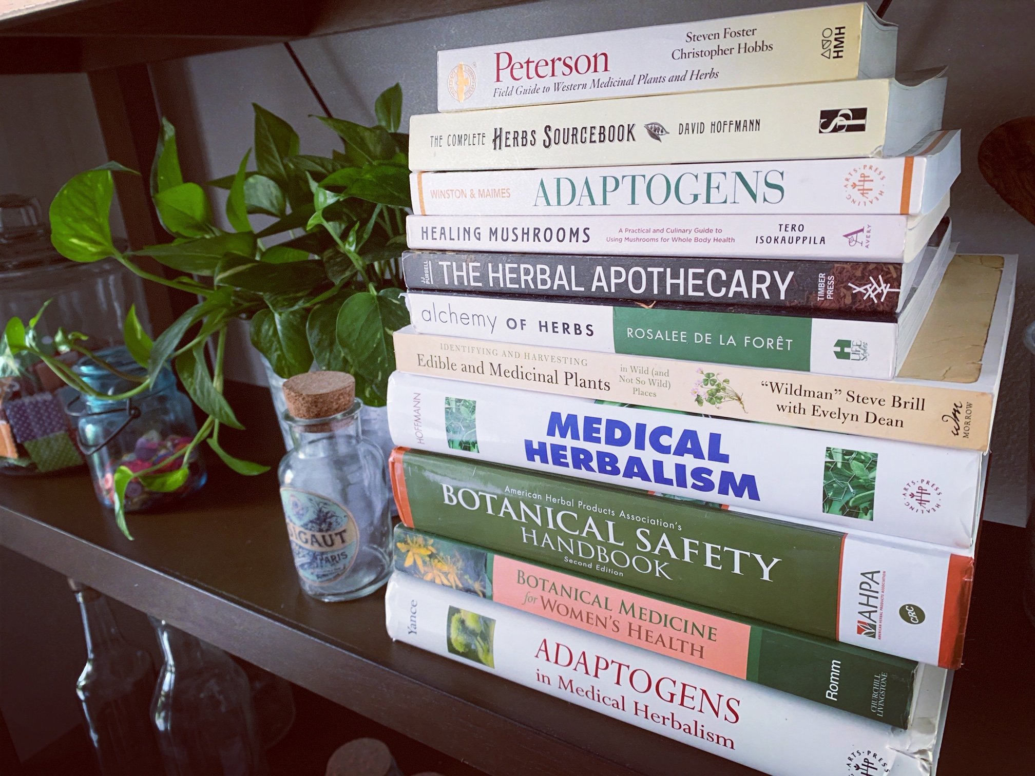 stack of herbal books on a shelf