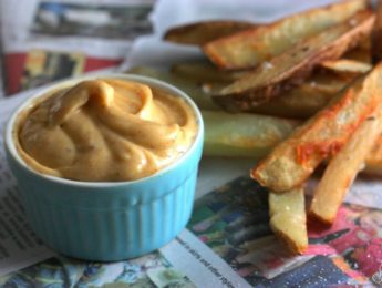 French fries on a table beside a ramekin of chipotle mayo