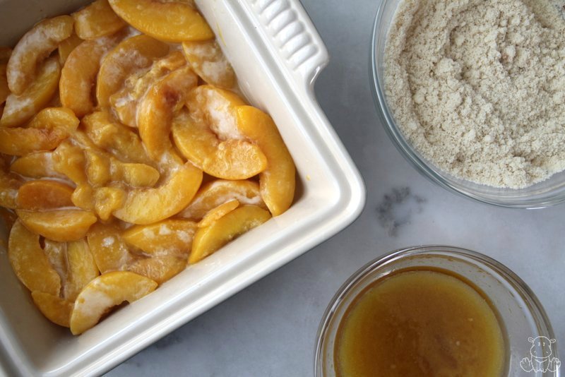 Peach filling mixture with topping ingredients ready to be mixed together