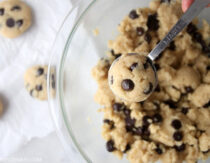 Scooping paleo chocolate chip cookie dough out of a bowl