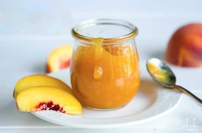 Peach freezer jam in a glass jar