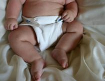 Baby in cloth diaper with diaper rash