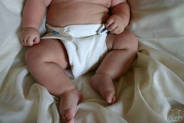 Baby in cloth diaper with diaper rash
